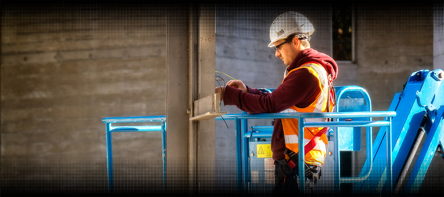 Electrical worker On a cherry picker, fixing the wiring.