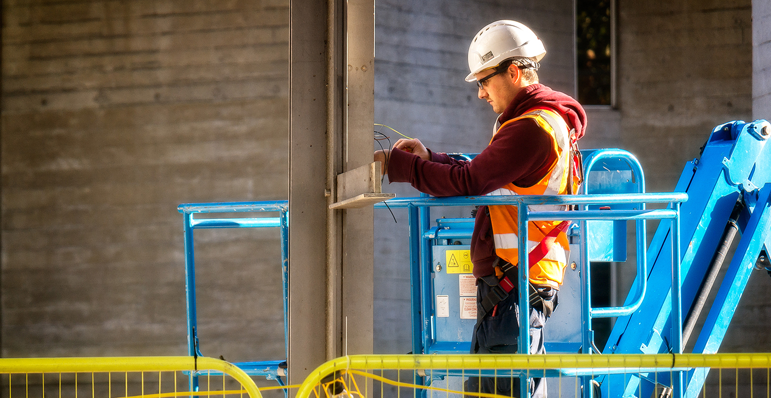 Electrical worker On a cherry picker, fixing the wiring.