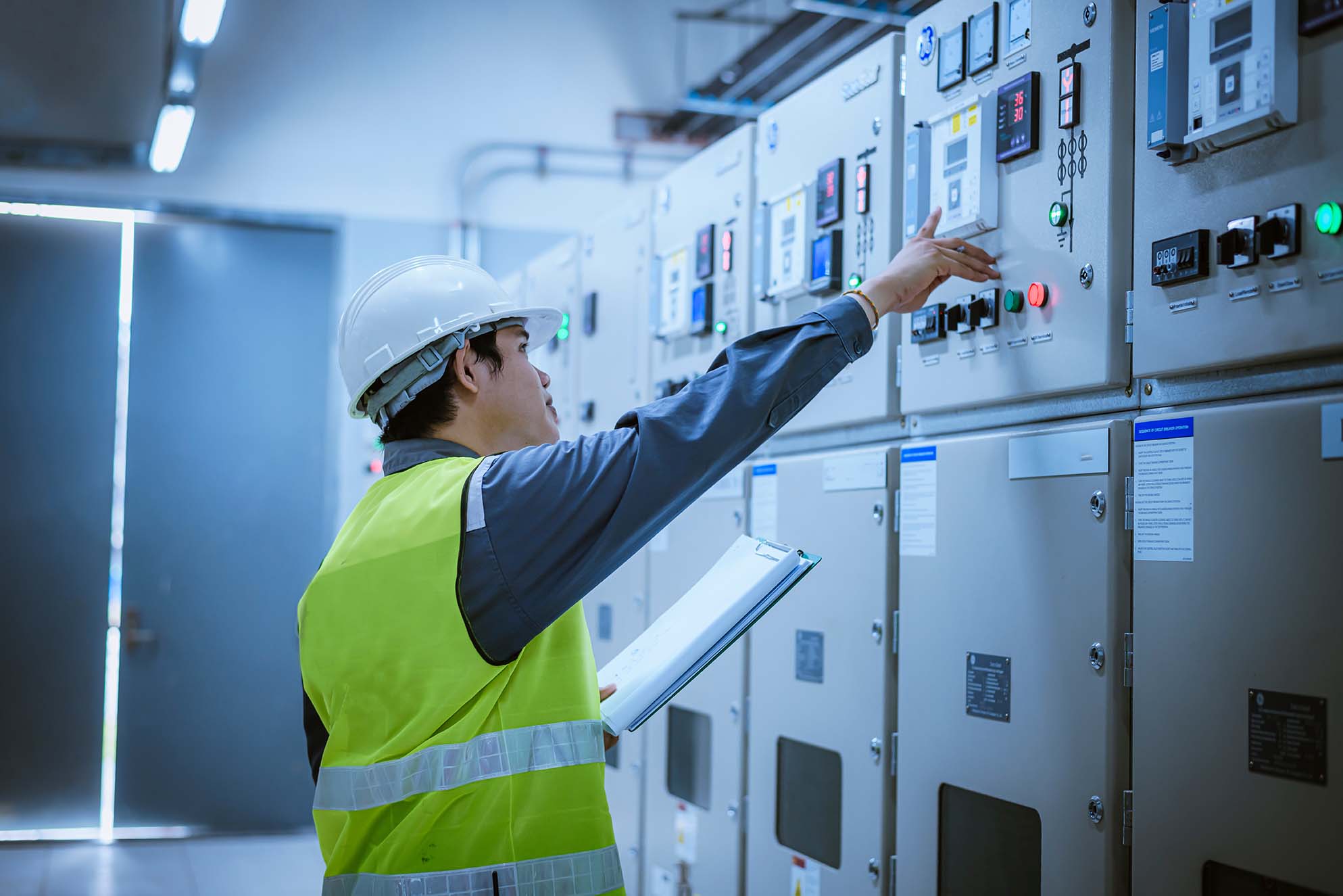 An electrician closely examining a panel