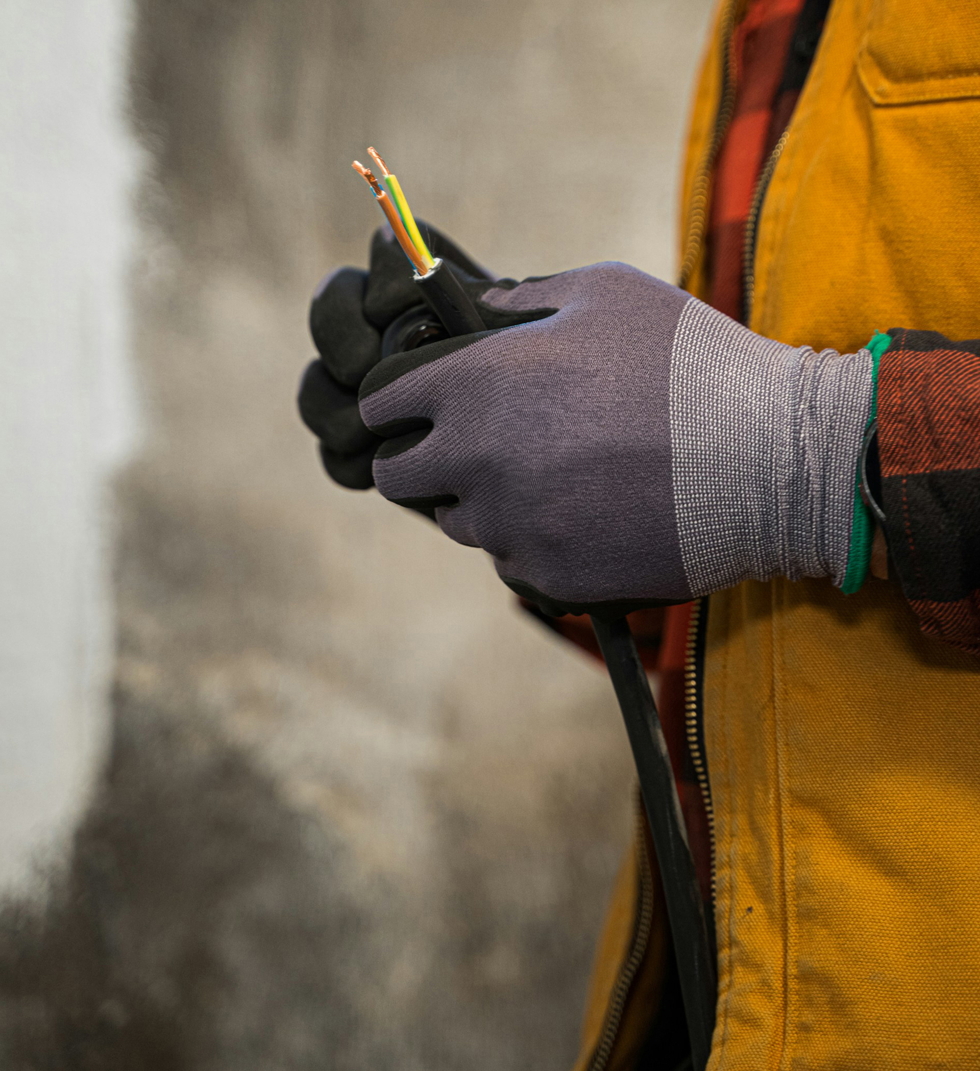 Image of an electrician splicing wires